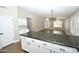 Open floorplan from kitchen island overlooking the living room with hardwood floors throughout the living space at 4002 E Rockwood Dr, Phoenix, AZ 85050