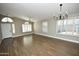 Open living room featuring wood floors, modern lighting, and shuttered windows for natural light and privacy at 4002 E Rockwood Dr, Phoenix, AZ 85050