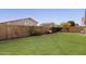 Spacious backyard featuring a well-maintained lawn and a block fence for added privacy at 4041 W Cielo Grande --, Glendale, AZ 85310