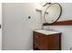 Bathroom featuring wood vanity with granite counter, brushed nickel faucet, and round mirror at 4041 W Cielo Grande --, Glendale, AZ 85310