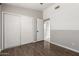 Bedroom featuring hardwood floors, closet, and a view to the hallway at 4041 W Cielo Grande --, Glendale, AZ 85310