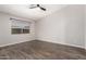 Spacious bedroom with dark wood-look floors, neutral paint and a large window for natural light at 4041 W Cielo Grande --, Glendale, AZ 85310