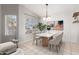 Dining area boasting tile floors, a modern light fixture, and a view of the backyard through the window at 4041 W Cielo Grande --, Glendale, AZ 85310
