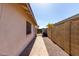 Side yard featuring a block wall, walkway, and gate at 4041 W Cielo Grande --, Glendale, AZ 85310