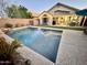 Sparkling backyard pool with water feature, patio, and lush green turf, ideal for relaxing at 4210 E Rosemonte Dr, Phoenix, AZ 85050