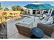 Inviting poolside patio area featuring comfortable seating and a serene backyard view at 4210 E Rosemonte Dr, Phoenix, AZ 85050