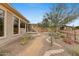 Beautiful backyard featuring desert landscaping, a built-in grill, and a covered patio area at 42123 N Long Cove Way, Anthem, AZ 85086