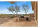 Stone patio with outdoor kitchen area and desert views at 42123 N Long Cove Way, Anthem, AZ 85086