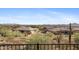 Desert backyard view overlooking neighboring houses and mountains on a sunny day at 42123 N Long Cove Way, Anthem, AZ 85086