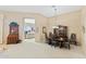 Elegant dining room with a wooden table set, china cabinet, and neutral carpeting at 42123 N Long Cove Way, Anthem, AZ 85086