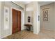 Warm entryway featuring a wooden door, tiled floor, and decorative furnishings at 42123 N Long Cove Way, Anthem, AZ 85086