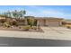 Charming home featuring a three-car garage and desert landscaping at 42123 N Long Cove Way, Anthem, AZ 85086