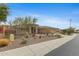 Attractive single story home exterior with desert landscaping, a low maintenance rock yard, and mature trees at 42123 N Long Cove Way, Anthem, AZ 85086