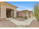 Inviting home entrance showcasing a covered porch, desert landscaping, and a three-car garage at 42123 N Long Cove Way, Anthem, AZ 85086