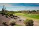 Beautiful golf course with lush green fairways, desert landscape, and a clear blue sky at 42123 N Long Cove Way, Anthem, AZ 85086