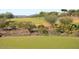 View of the lush green fairways of the golf course with mature desert vegetation on the course at 42123 N Long Cove Way, Anthem, AZ 85086