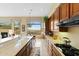 Open kitchen featuring wooden cabinets, an island, a breakfast bar, and an amazing mountain view at 42123 N Long Cove Way, Anthem, AZ 85086