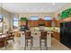 Bright kitchen featuring dark wood cabinetry, a breakfast bar, and neutral countertops at 42123 N Long Cove Way, Anthem, AZ 85086