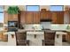 Charming kitchen area featuring wood cabinets, modern appliances, and breakfast bar seating at 42123 N Long Cove Way, Anthem, AZ 85086