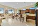 Bright kitchen featuring wooden cabinets, granite countertops, and a breakfast bar seating area at 42123 N Long Cove Way, Anthem, AZ 85086