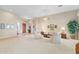 Bright living room with tile and carpet flooring, neutral walls, and a ceiling fan at 42123 N Long Cove Way, Anthem, AZ 85086