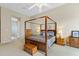 A primary bedroom with a four-poster bed is brightly lit with lamps on each side at 42123 N Long Cove Way, Anthem, AZ 85086