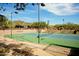 A well-maintained tennis court under a clear blue sky at 42123 N Long Cove Way, Anthem, AZ 85086