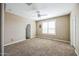 Bedroom with neutral carpet, ceiling fan, and window with shutter at 42256 W Lucera Ln, Maricopa, AZ 85138