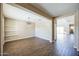 Open dining room with wood-look tile flooring, modern light fixture, and neutral paint at 42256 W Lucera Ln, Maricopa, AZ 85138