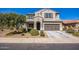 Traditional two-story home with a well-manicured front yard and a two car garage at 42256 W Lucera Ln, Maricopa, AZ 85138