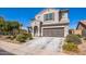 Exterior view of a two-story home with manicured landscaping and a spacious driveway at 42256 W Lucera Ln, Maricopa, AZ 85138