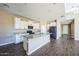 Modern kitchen with granite countertops, a spacious island, and stainless steel appliances at 42256 W Lucera Ln, Maricopa, AZ 85138