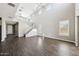 Large living room with high ceilings, a staircase, and wood-look tile flooring throughout at 42256 W Lucera Ln, Maricopa, AZ 85138