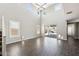 Spacious living room featuring high ceilings, large windows, and sliding glass doors to the backyard at 42256 W Lucera Ln, Maricopa, AZ 85138