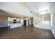 Open living space with modern kitchen, high ceilings, and wood-look tile flooring at 42256 W Lucera Ln, Maricopa, AZ 85138