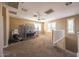 Large carpeted loft with ceiling fan and abundant natural light at 42256 W Lucera Ln, Maricopa, AZ 85138