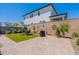 Spacious backyard featuring artificial turf, brick pavers, and an outdoor dining area at 4332 N 197Th Dr, Litchfield Park, AZ 85340