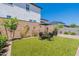 Lush backyard with artificial turf, brick pavers, and a charming outdoor dining area at 4332 N 197Th Dr, Litchfield Park, AZ 85340