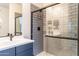 Bathroom features a sink, vanity and a glass-enclosed shower with gray tiling at 4332 N 197Th Dr, Litchfield Park, AZ 85340