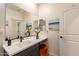 Stylish bathroom features a modern vanity with a white countertop and black faucet fixtures at 4332 N 197Th Dr, Litchfield Park, AZ 85340