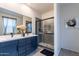 Modern bathroom featuring dual sinks, a stylish vanity, and a glass-enclosed shower at 4332 N 197Th Dr, Litchfield Park, AZ 85340