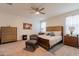 Cozy bedroom with a ceiling fan, plush carpet, and warm, inviting natural light at 4332 N 197Th Dr, Litchfield Park, AZ 85340