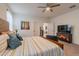 Bedroom featuring a spacious bed with yellow accents, TV, and two entryways at 4332 N 197Th Dr, Litchfield Park, AZ 85340