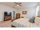 Bedroom features a large bed with yellow accents, TV, and a modern dresser at 4332 N 197Th Dr, Litchfield Park, AZ 85340