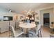 Open concept dining room with modern lighting, seamlessly connects to the kitchen and living area, perfect for entertaining at 4332 N 197Th Dr, Litchfield Park, AZ 85340