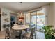 Inviting dining area with patio view, features a modern light fixture and access to the outdoor living space at 4332 N 197Th Dr, Litchfield Park, AZ 85340