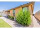 Exterior view of the home with lush green landscaping and a brick paver walkway at 4332 N 197Th Dr, Litchfield Park, AZ 85340