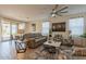 Bright living room with large windows, ceiling fan, stylish furniture and an open floor plan at 4332 N 197Th Dr, Litchfield Park, AZ 85340