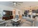 Open-concept living area showcasing a modern kitchen with a granite island and a comfortable seating area at 4332 N 197Th Dr, Litchfield Park, AZ 85340