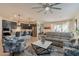 Open-concept living area showcasing a modern kitchen with a granite island and a comfortable seating area at 4332 N 197Th Dr, Litchfield Park, AZ 85340